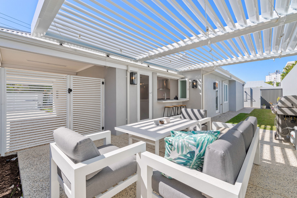 This is an example of a contemporary backyard patio in Perth with a pergola.
