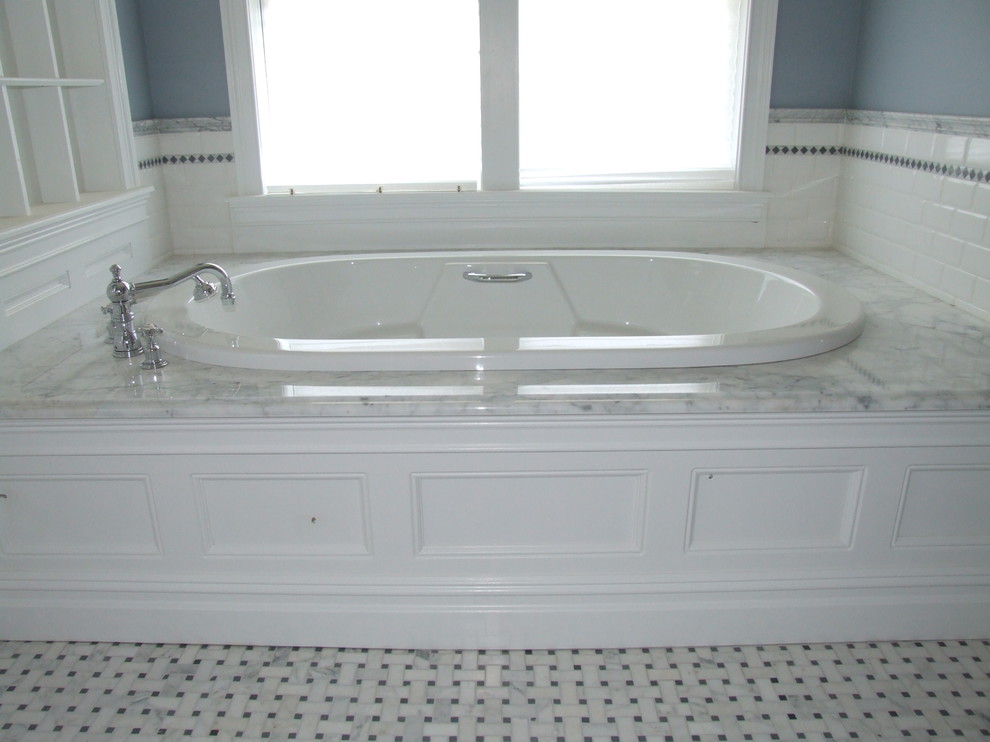 Example of a large classic master white tile and subway tile marble floor bathroom design in New York with recessed-panel cabinets, white cabinets, marble countertops, an undermount sink, a two-piece toilet and blue walls