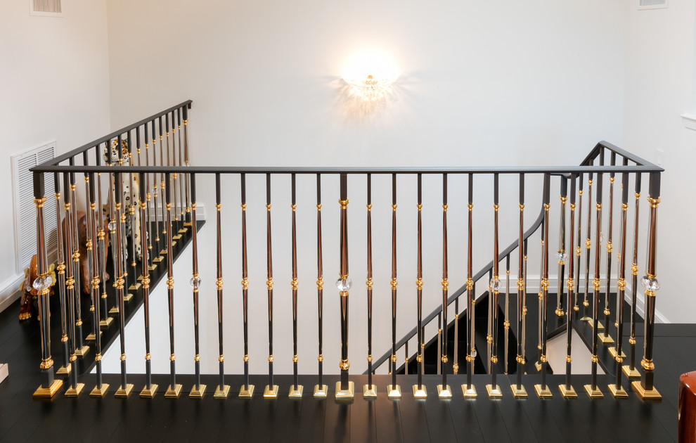 This is an example of a mid-sized eclectic wood l-shaped staircase in New York with wood risers and metal railing.
