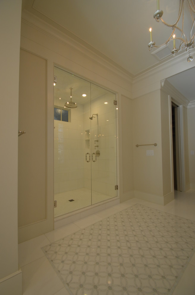 This is an example of a large transitional master bathroom in Atlanta with shaker cabinets, white cabinets, an undermount tub, an alcove shower, a two-piece toilet, beige tile, white tile, porcelain tile, beige walls, marble floors, an undermount sink and engineered quartz benchtops.