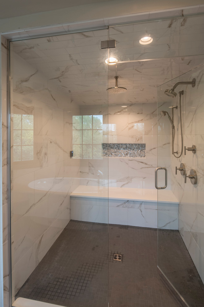 Photo of a large contemporary master bathroom in Other with flat-panel cabinets, dark wood cabinets, a freestanding tub, a double shower, white tile, marble, white walls, porcelain floors, an undermount sink, engineered quartz benchtops, grey floor and a hinged shower door.
