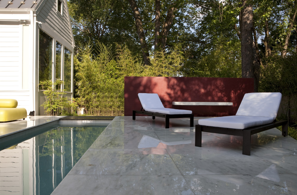 Inspiration for a mid-sized transitional backyard patio in DC Metro with no cover and natural stone pavers.