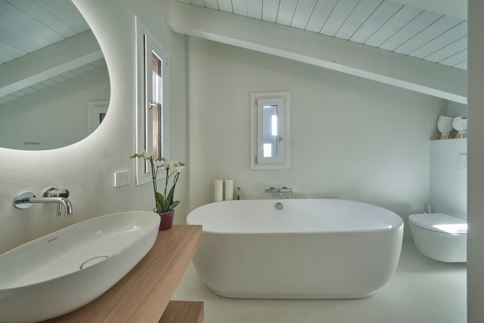 Источник вдохновения для домашнего уюта: ванная комната среднего размера в стиле модернизм с открытыми фасадами, светлыми деревянными фасадами, ванной в нише, душем без бортиков, инсталляцией, белыми стенами, настольной раковиной, столешницей из дерева, белым полом, душем с раздвижными дверями, тумбой под одну раковину, подвесной тумбой и балками на потолке