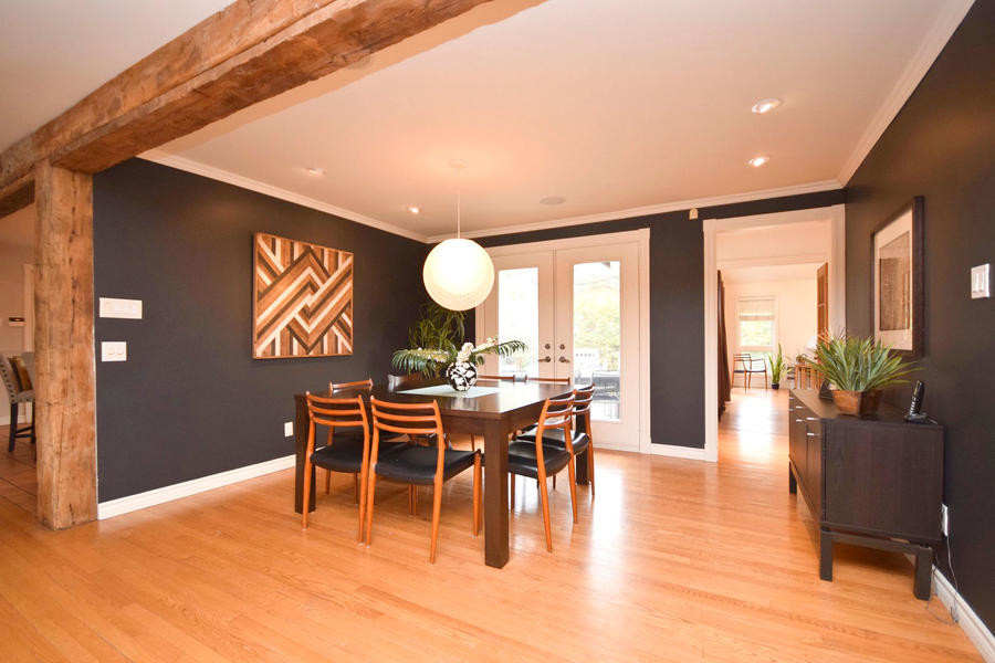 This is an example of a mid-sized eclectic dining room in Ottawa with black walls and medium hardwood floors.