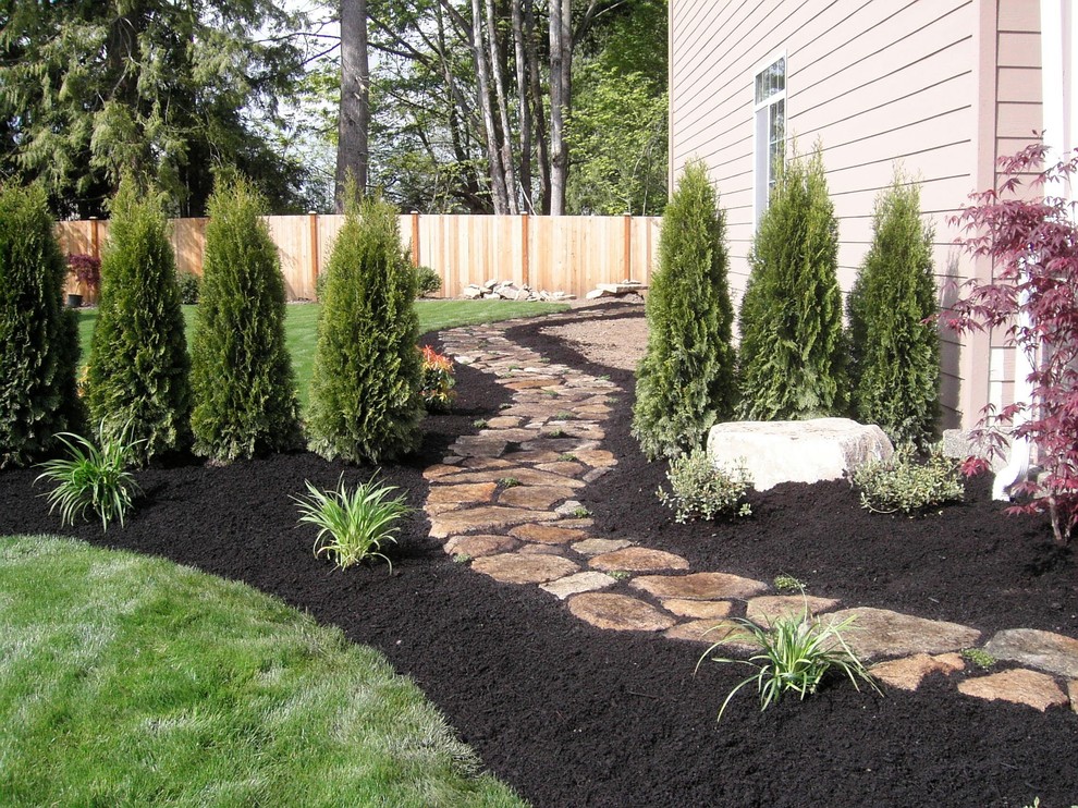 Stone walkway with beds, plants and lawn installed
