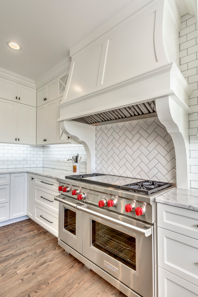 Transitional open concept kitchen photo in Chicago with white backsplash, subway tile backsplash and two islands