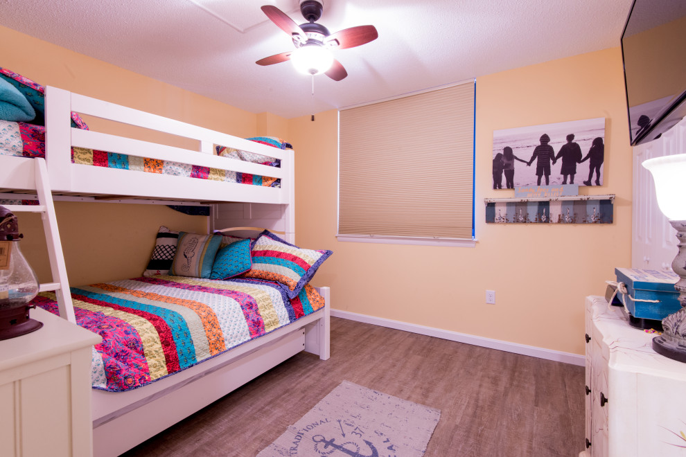 Mid-sized beach style kids' room in Other with laminate floors.