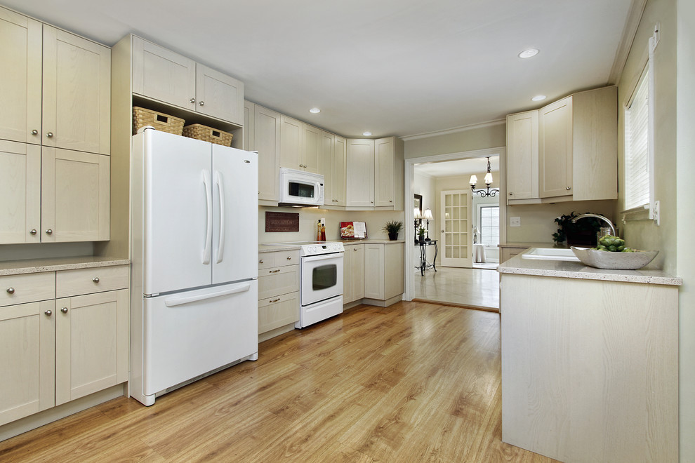 Kitchen - large light wood floor kitchen idea in Minneapolis with a drop-in sink and white appliances