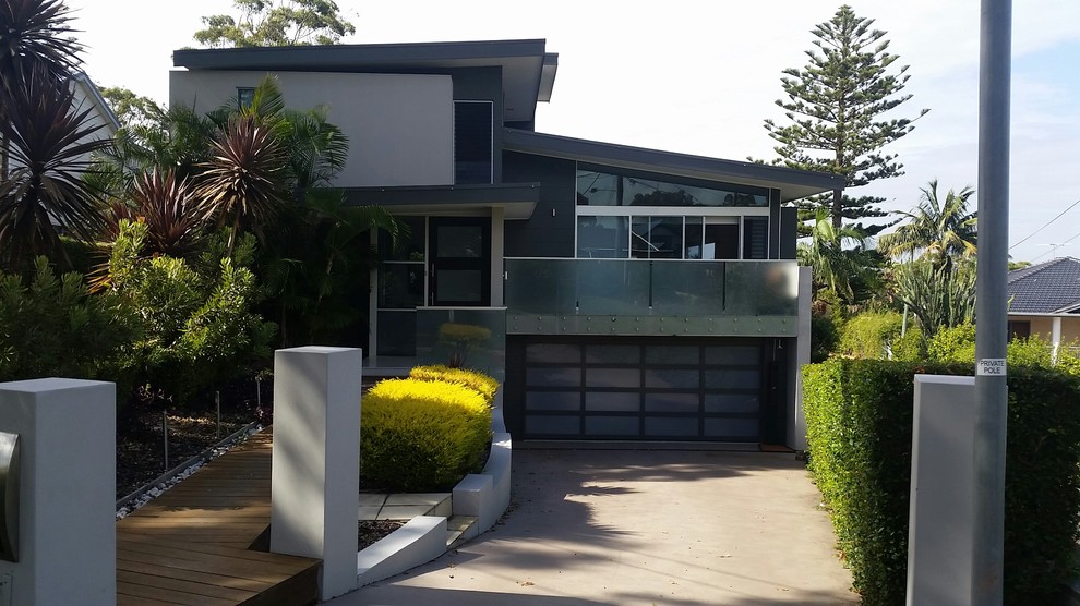 Design ideas for a mid-sized contemporary two-storey grey exterior in Sydney with mixed siding.
