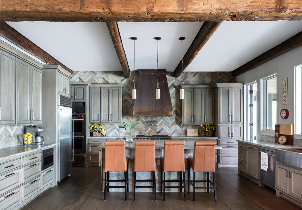 Design ideas for a country u-shaped kitchen in Houston with a farmhouse sink, shaker cabinets, distressed cabinets, multi-coloured splashback, stainless steel appliances, dark hardwood floors, with island and brown floor.