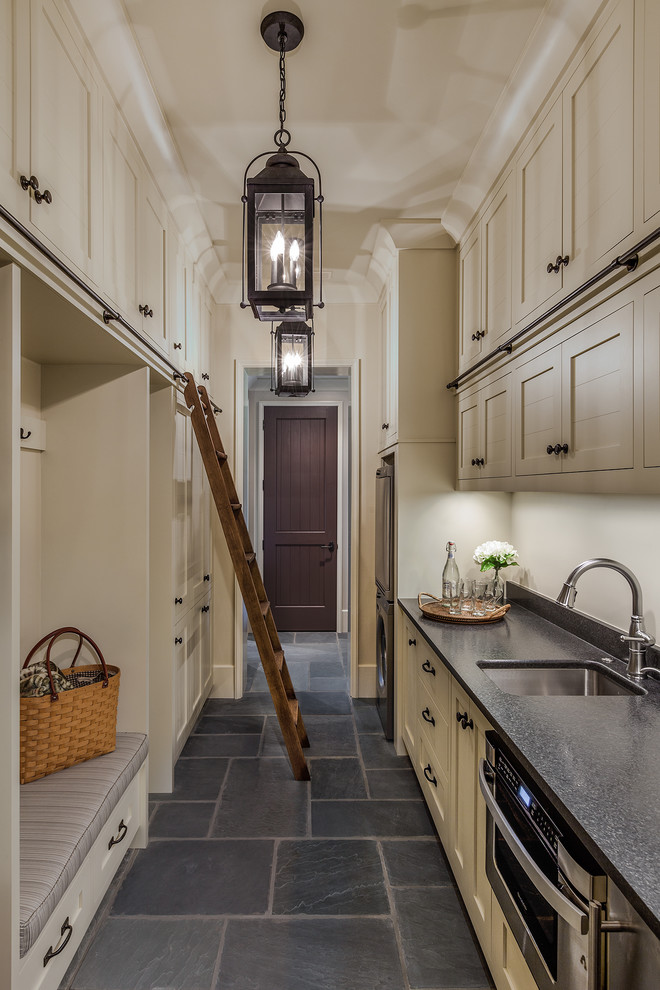 This is an example of a mid-sized transitional galley separate kitchen in Other with an undermount sink, shaker cabinets, white cabinets, quartz benchtops, stainless steel appliances, slate floors and no island.