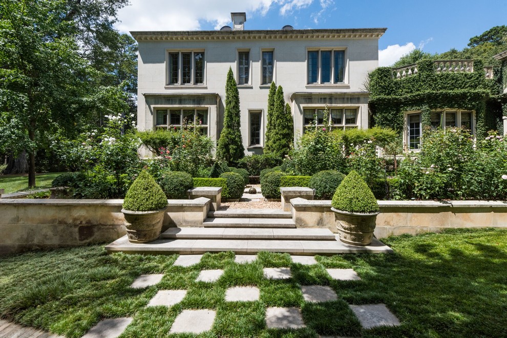 This is an example of a traditional formal garden in Atlanta with a container garden and natural stone pavers.
