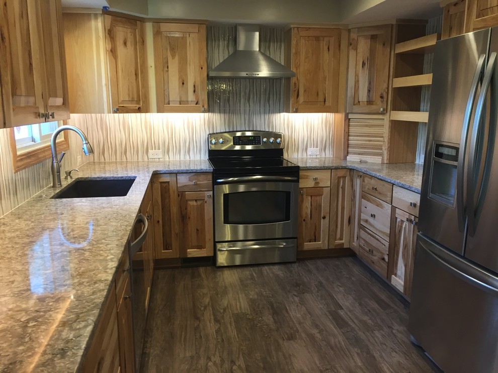 Eat-in kitchen - mid-sized rustic u-shaped laminate floor and brown floor eat-in kitchen idea in Omaha with an undermount sink, raised-panel cabinets, light wood cabinets, quartz countertops, beige backsplash, porcelain backsplash, stainless steel appliances, an island and gray countertops
