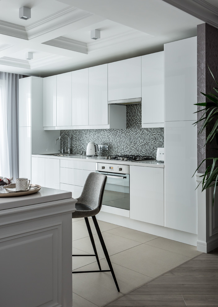 Design ideas for a contemporary kitchen in Moscow with a drop-in sink, flat-panel cabinets, white cabinets, grey splashback, mosaic tile splashback, stainless steel appliances, beige floor and white benchtop.