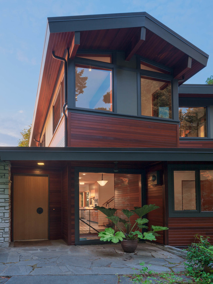 Inspiration for a mid-sized midcentury two-storey exterior in Seattle with wood siding.