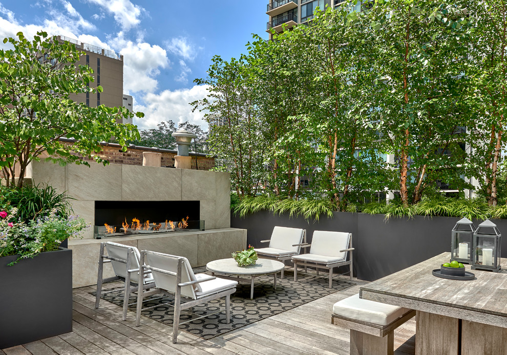 Photo of a contemporary rooftop and rooftop deck in Chicago with with fireplace and no cover.