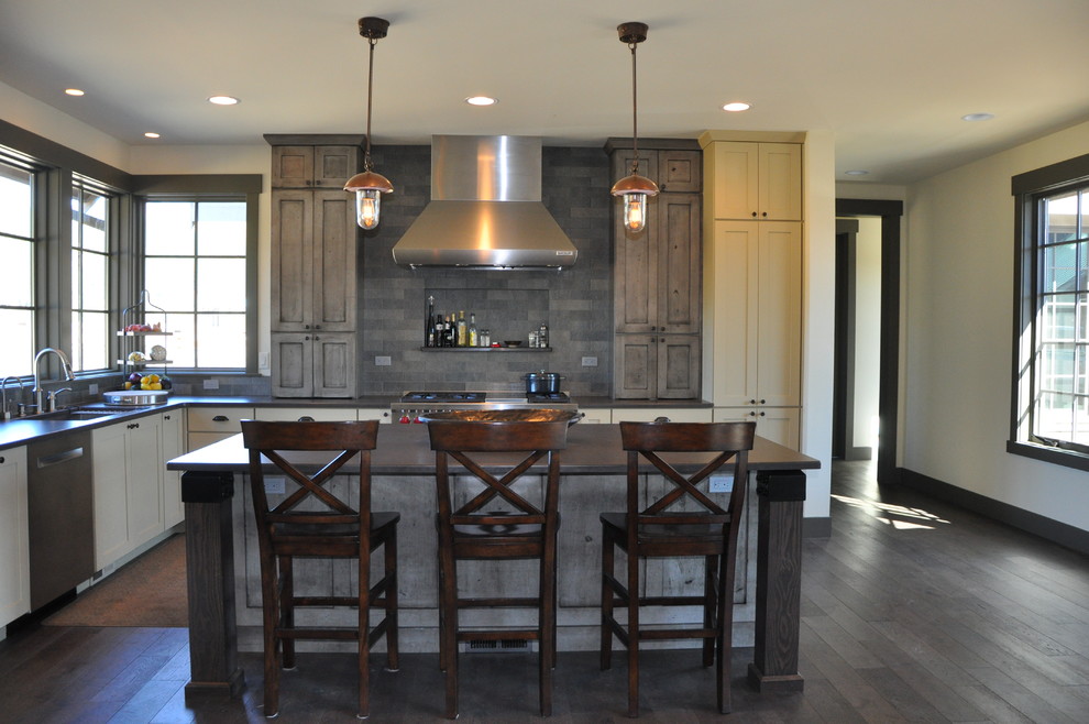 Large mountain style l-shaped medium tone wood floor eat-in kitchen photo in Seattle with an undermount sink, shaker cabinets, distressed cabinets, quartz countertops, gray backsplash, stone tile backsplash, stainless steel appliances and an island