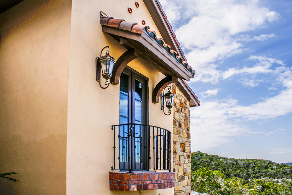 Photo of a mediterranean balcony in Austin with an awning.