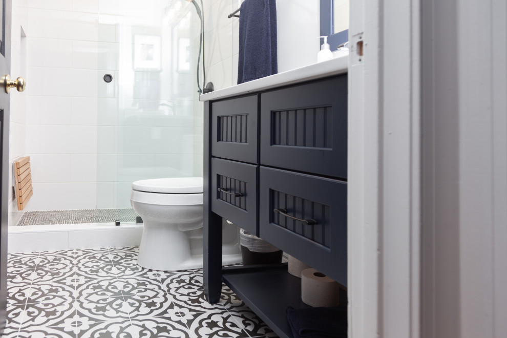 Bild på ett litet funkis vit vitt badrum, med möbel-liknande, blå skåp, vit kakel, porslinskakel, klinkergolv i keramik, ett undermonterad handfat, bänkskiva i kvarts och dusch med skjutdörr