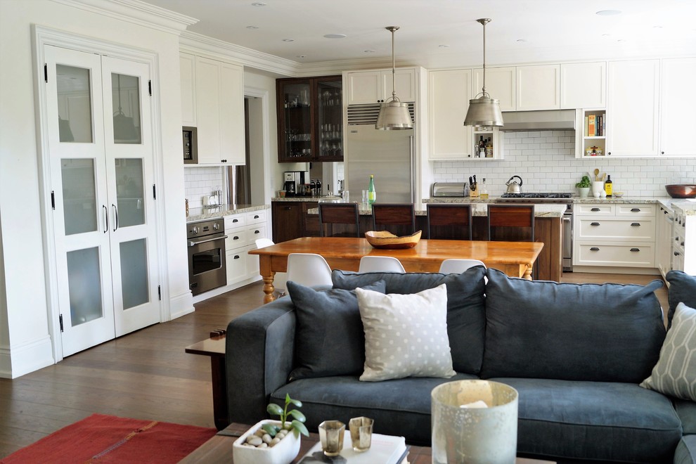 Open concept kitchen - large transitional u-shaped medium tone wood floor open concept kitchen idea in Toronto with a drop-in sink, shaker cabinets, white cabinets, marble countertops, white backsplash, subway tile backsplash, stainless steel appliances and an island