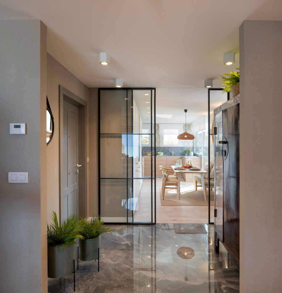 Photo of a large transitional hallway in Bilbao with grey walls, travertine floors, grey floor and wallpaper.