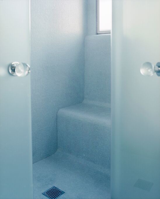 Small contemporary bathroom with blue walls, ceramic floors, with a sauna, blue floor and a hinged shower door.