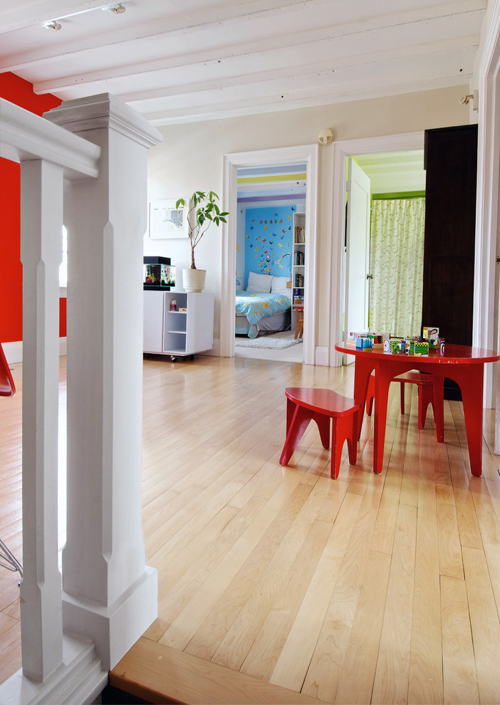 This is an example of a transitional gender-neutral kids' room in Toronto with beige walls and light hardwood floors.