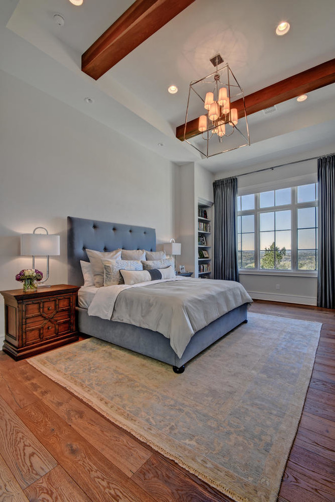 Photo of a mid-sized transitional master bedroom in Austin with white walls, dark hardwood floors, no fireplace and brown floor.