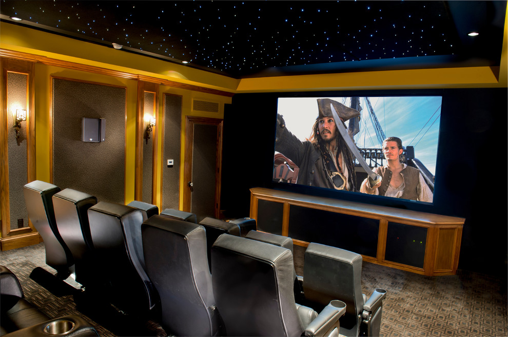 Photo of a traditional home theatre in Los Angeles with beige walls, carpet and a projector screen.
