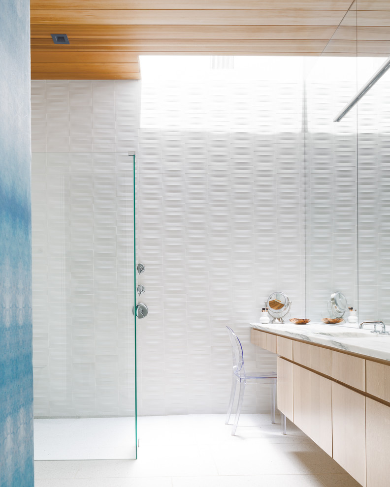 Inspiration for a modern bathroom in Austin with flat-panel cabinets, light wood cabinets, a curbless shower, white tile, an undermount sink, white floor and white benchtops.