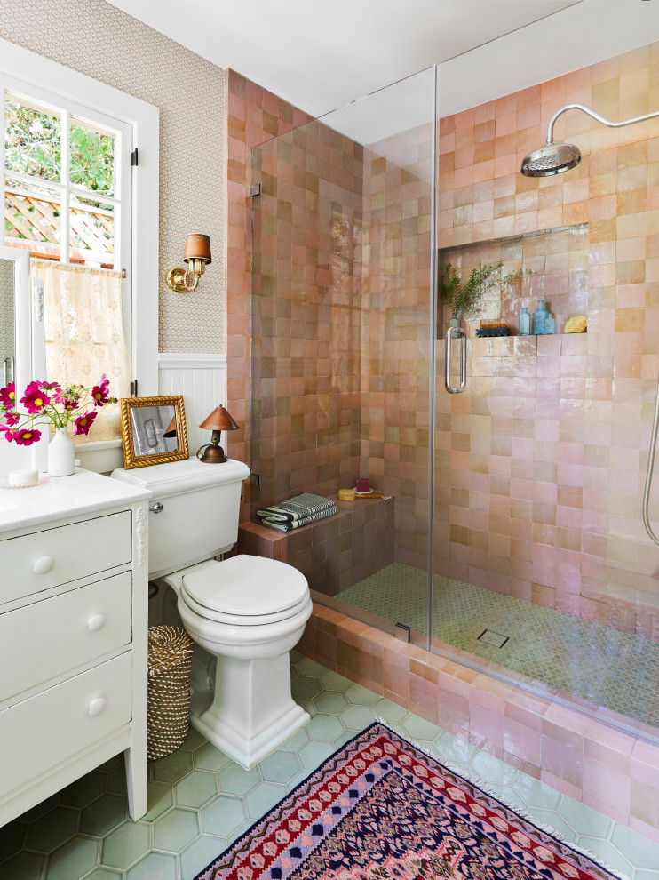 This is an example of an eclectic bathroom in Los Angeles with a two-piece toilet, ceramic floors, green floor, a shower seat and panelled walls.