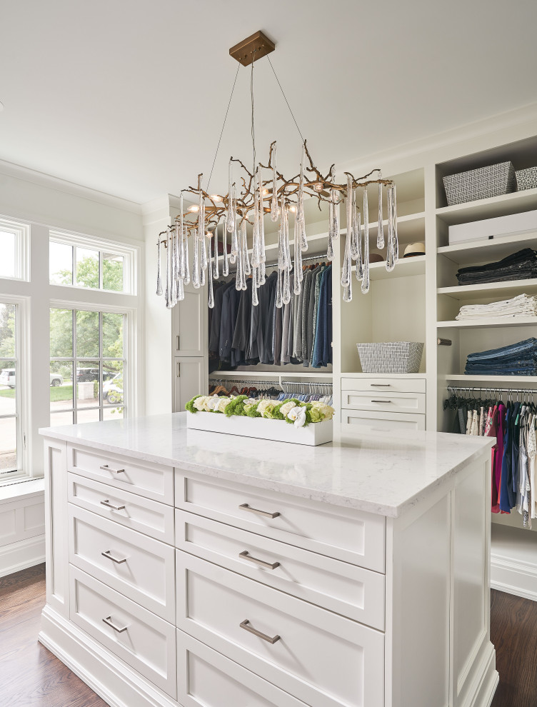 Example of a mid-sized transitional women's medium tone wood floor and brown floor walk-in closet design in Detroit with shaker cabinets and white cabinets