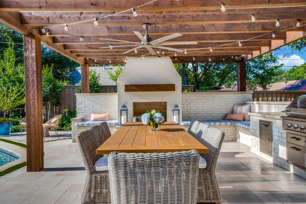 Expansive bohemian back patio in Dallas with a fireplace and a pergola.