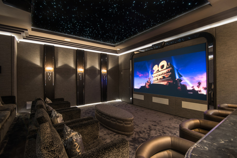 This is an example of an expansive traditional enclosed home theatre in Belfast with grey walls, carpet, a projector screen and grey floor.