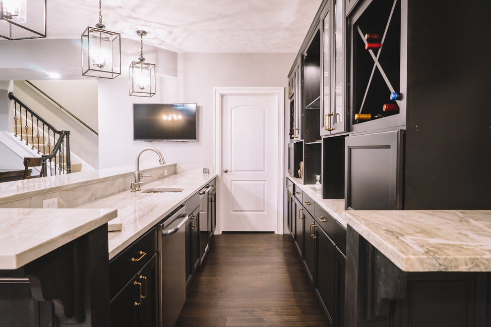 Inspiration for a large transitional galley dark wood floor kitchen remodel with gray walls, an undermount sink, recessed-panel cabinets, marble countertops, black cabinets and mirror backsplash