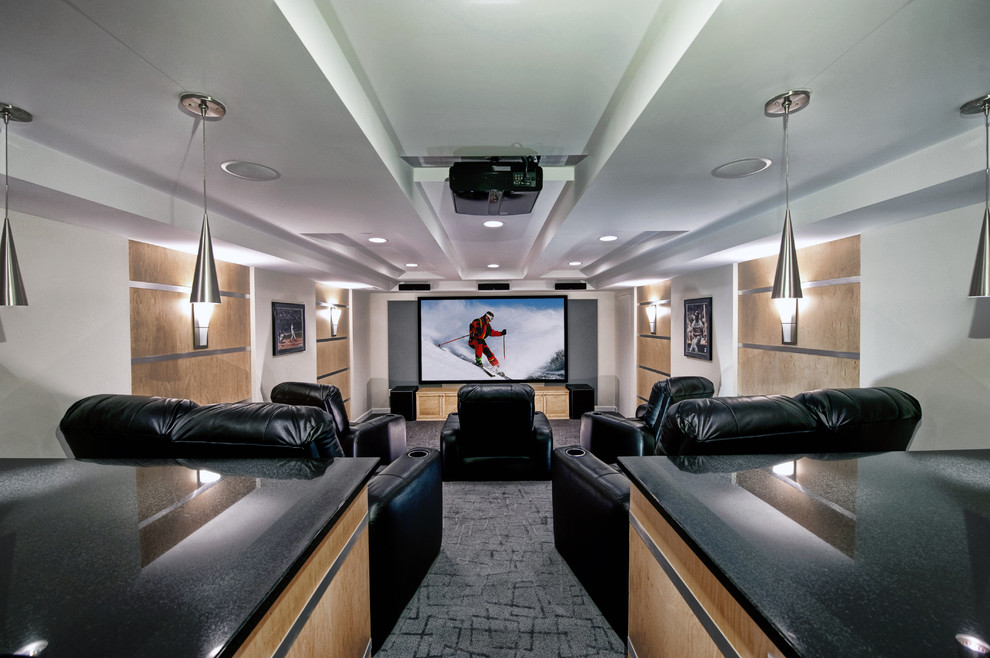This is an example of a mid-sized contemporary open concept home theatre in DC Metro with multi-coloured walls, carpet, a projector screen and grey floor.