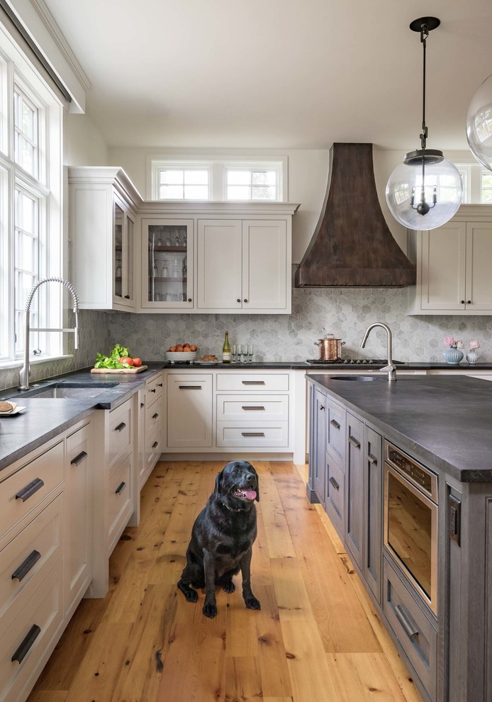 Design ideas for a large transitional l-shaped kitchen in Boston with white cabinets, soapstone benchtops, grey splashback, ceramic splashback, stainless steel appliances, medium hardwood floors, a single-bowl sink, shaker cabinets and with island.