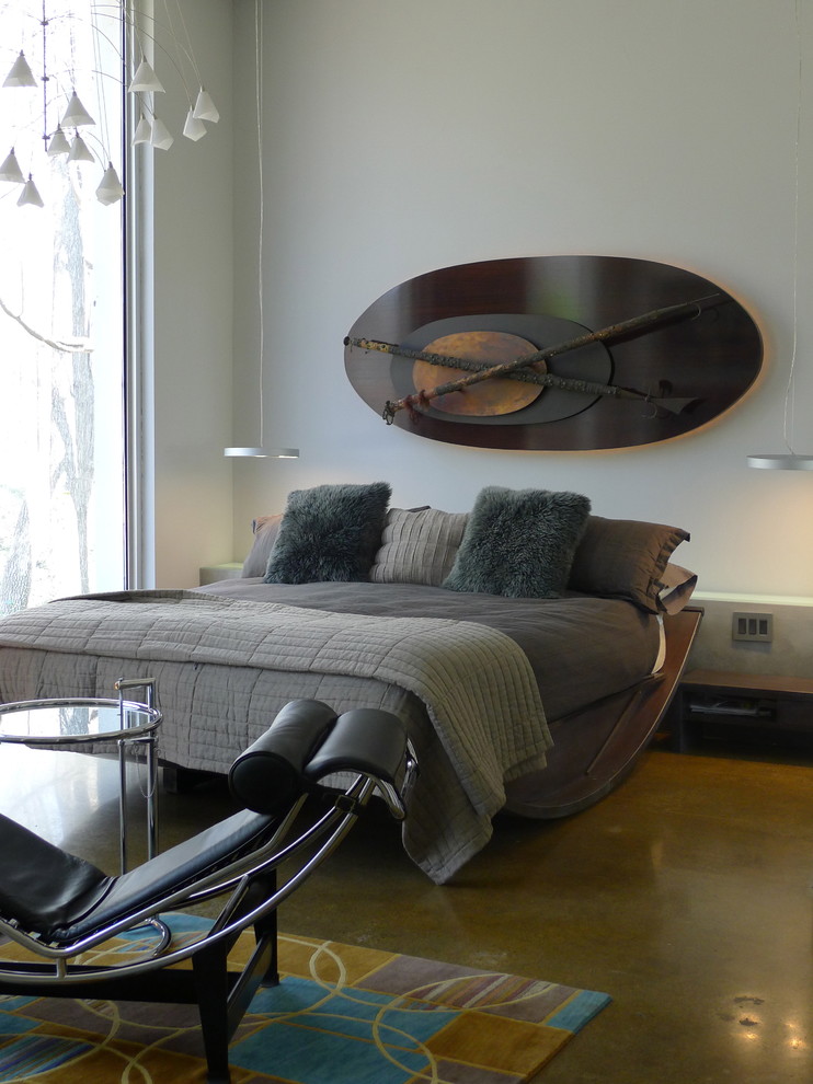 Photo of a contemporary bedroom in Indianapolis with concrete floors.