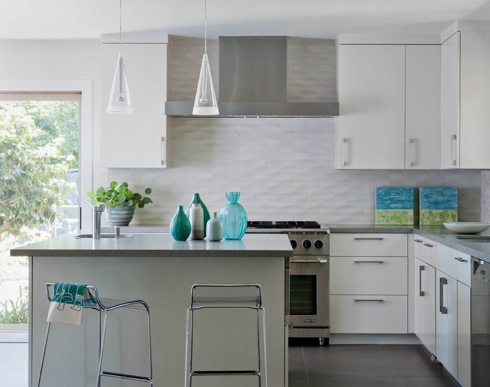 Design ideas for a transitional kitchen in San Francisco with stainless steel appliances, flat-panel cabinets, white cabinets, quartz benchtops, white splashback and porcelain splashback.