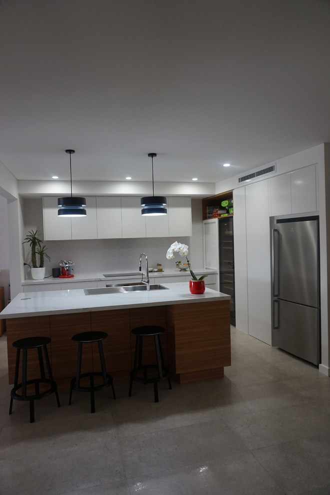 Design ideas for a mid-sized contemporary l-shaped eat-in kitchen in Sydney with a drop-in sink, open cabinets, white cabinets, quartz benchtops, white splashback, porcelain splashback, stainless steel appliances, ceramic floors and with island.
