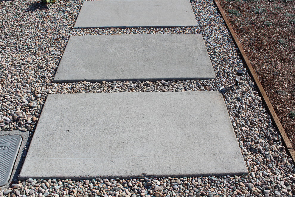 Inspiration for a mid-sized contemporary drought-tolerant and full sun front yard concrete paver garden path in Orange County.