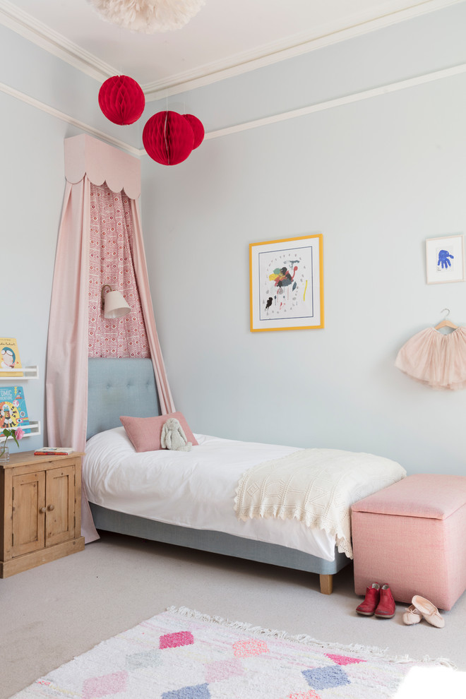 This is an example of a traditional kids' bedroom for kids 4-10 years old and girls in Edinburgh with blue walls, carpet and beige floor.