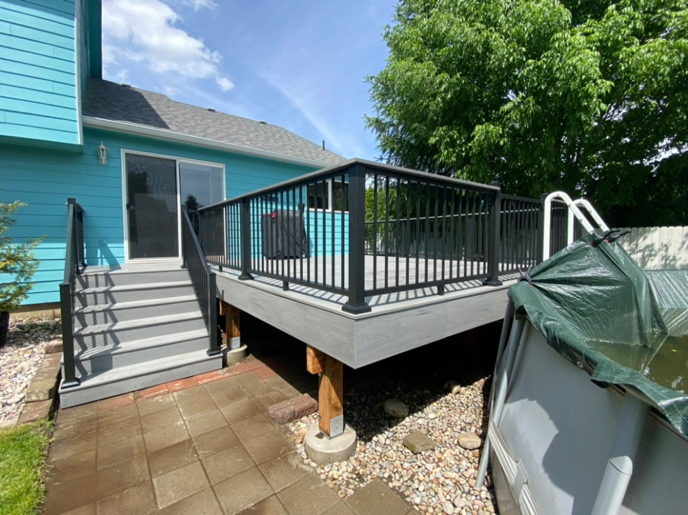Example of a large backyard metal railing deck design in Seattle
