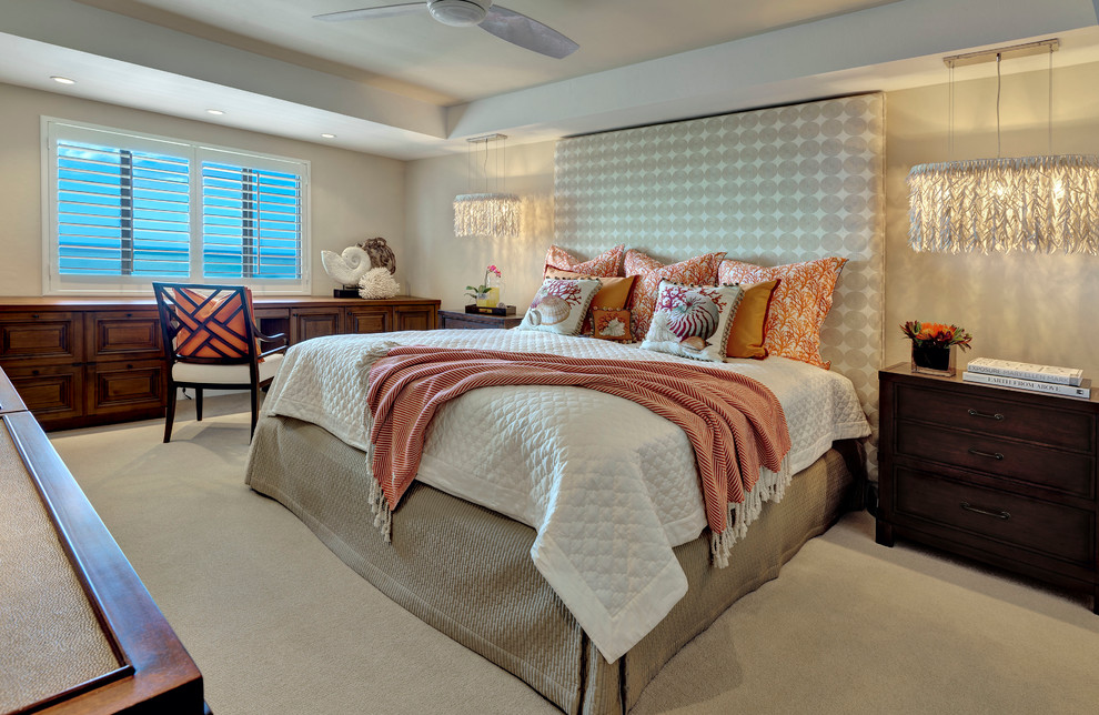 Beach style bedroom in Tampa with beige walls and carpet.