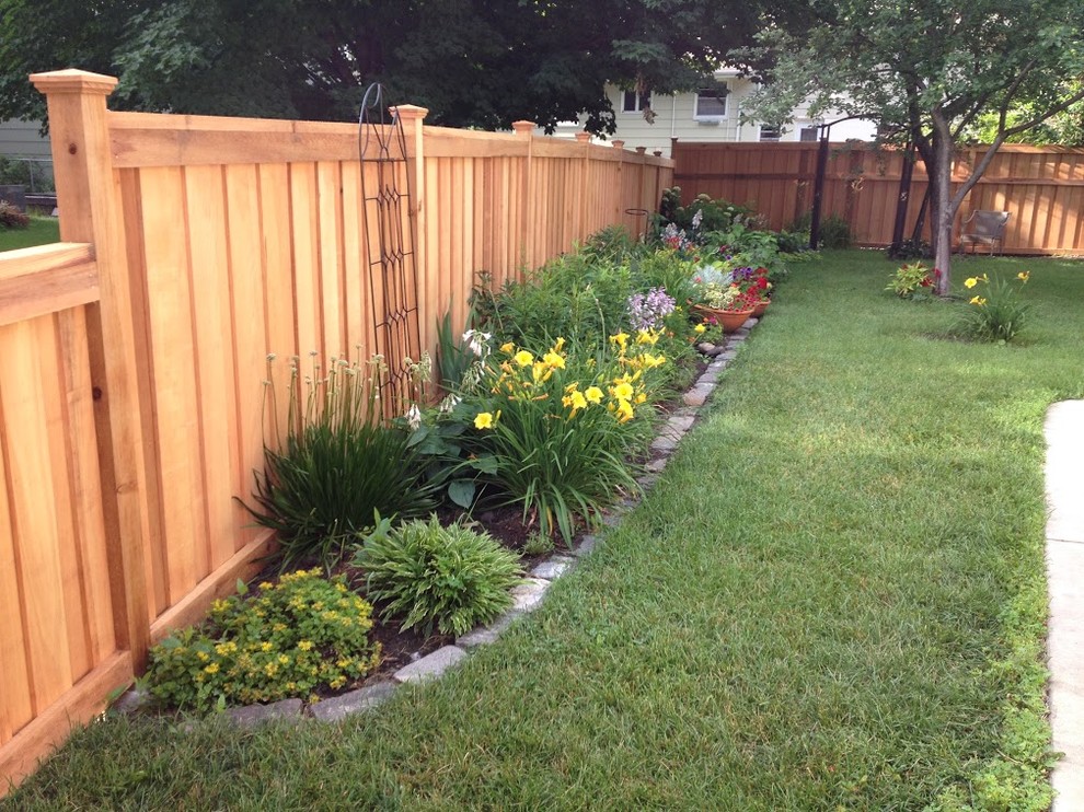 Photo of a large transitional backyard partial sun formal garden in Minneapolis with a garden path and mulch.