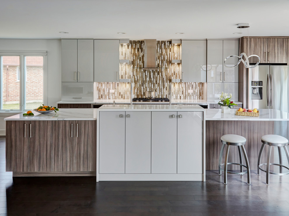 Design ideas for a large contemporary open plan kitchen in Chicago with flat-panel cabinets, grey cabinets, quartz benchtops, multi-coloured splashback, stainless steel appliances, dark hardwood floors, with island, brown floor, white benchtop and matchstick tile splashback.