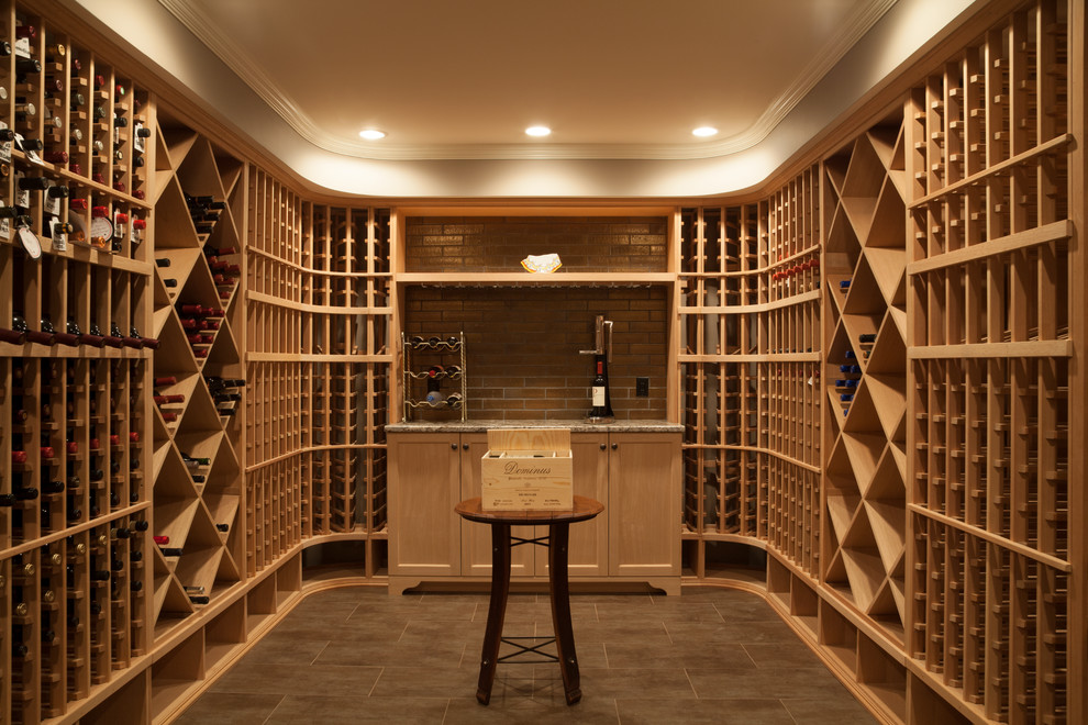 This is an example of a mid-sized traditional wine cellar in Boston with porcelain floors and storage racks.