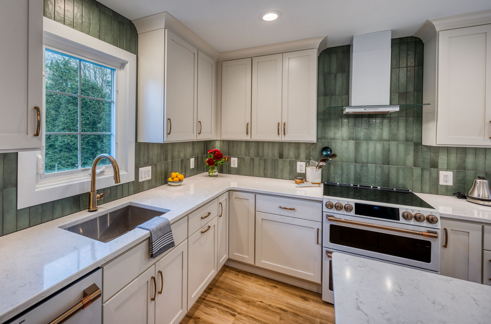 Kitchen - large transitional kitchen idea in DC Metro with flat-panel cabinets, white cabinets, quartz countertops, green backsplash, ceramic backsplash, an island and white countertops