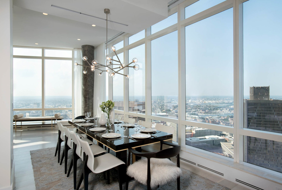 Photo of a contemporary separate dining room in Boston with white walls, light hardwood floors and grey floor.
