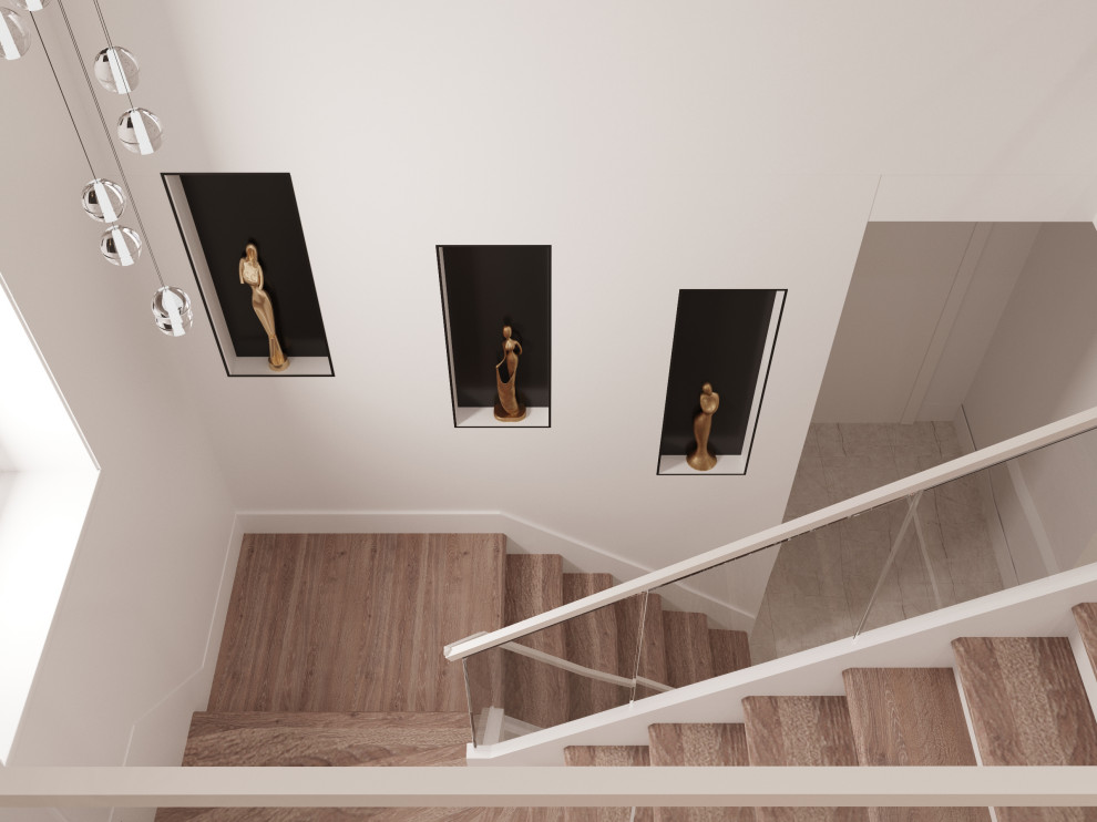 Свежая идея для дизайна: большая угловая лестница в современном стиле с ступенями из плитки, металлическими перилами и панелями на стенах без подступенок - отличное фото интерьера